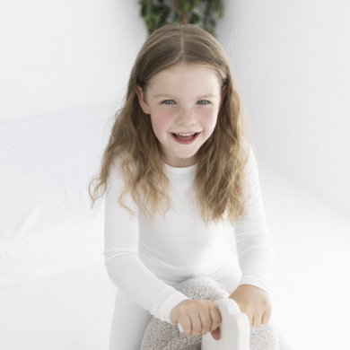 playing active child wearing skin-friendly HappySkin long sleeve eczema round neck top for natural skin relief