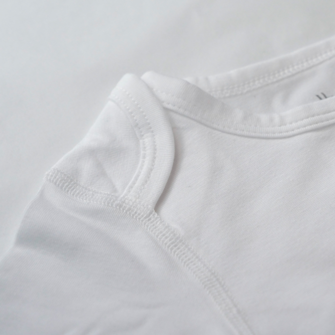 close-up textile and flat seam details eczema sleepsuit