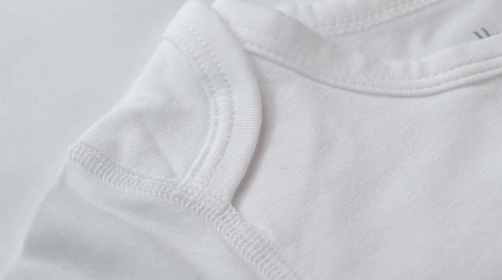 close-up textile and flat seam details eczema sleepsuit