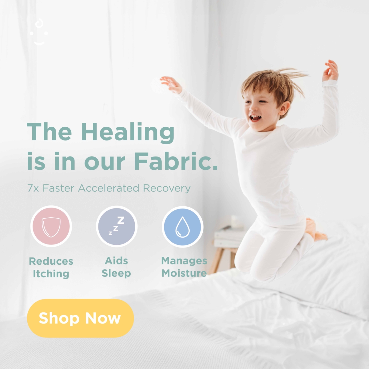 smiling boy jump on bed and wearing eczema pyjamas