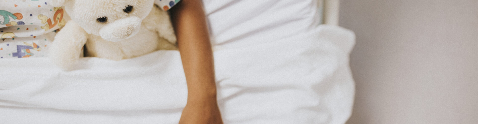 Little eczema girl sleeping in a white bed