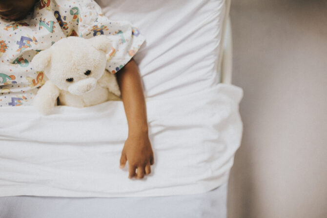 Little eczema girl sleeping in a white bed